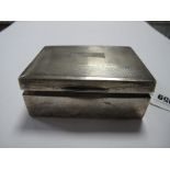 A Hallmarked Silver Cigarette Box, of rectangular form with engine turned lid, 11.5cm wide.