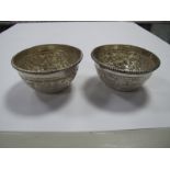 A Pair of Decorative Dishes, each detailed in relief with flowerheads and scrolls, stamped "Sterling