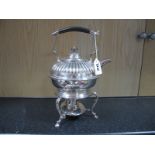 An Electroplated Tea Kettle on Burner Stand, of semi reeded form on plain scroll base, with