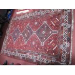 A Middle Eastern Wool Tasselled Rug, circa early to mid XX Century, featuring three large adjoined