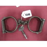 Hiatt Metal Handcuffs, with key, stamped No. 86, circa 1900.