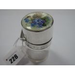 A Hallmarked Silver and Enamel Topped Glass Jar, the hinged lid detailed with blue and mauve