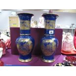 A Pair of Carlton Ware Vases of bulbous form with elongated neck, each with gilt chinoiserie scene