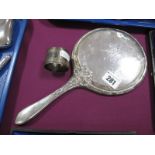 A Hallmarked Silver Backed Hand Mirror, embossed decoration of ribbon tied and reeded borders,