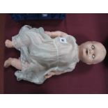 An Early Mid XX Century Baby Doll, head stamped HW Jubilee, composition body.