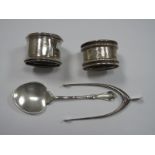 Novelty Hallmarked Silver Wishbone Sugar Tongs, a hallmarked silver spoon and two napkin rings. (4)