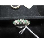 An 18ct White Gold Emerald and Diamond Set Dress Ring, alternately set with uniform stones, on a