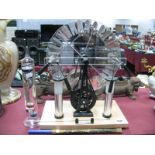 A Van De Graaff Generator, laboratory thermometer, temperature gauge. (3)