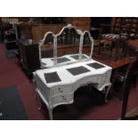 A Cream Painted Dressing Table, with five drawers to serpentine front, all over gilt highlights on