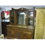 An Early XX Century Mirror Back Sideboard, top with a shaped pediment, over a central mirror,