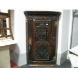 An XVIII Century and Later Oak Flat Fronted Corner Cupboard, with a dentil cornice , carved door,