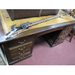 An Early XX Century Oak Pedestal Desk, with crossbanded top, brown leather sciver, central drawer,