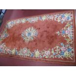 A XX Century Wood Rug, rust coloured with floral decoration.