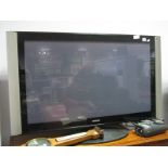 A Hitachi Digital Colour Plasma TV, model no 42PD9700U, on stand together with a mahogany TV