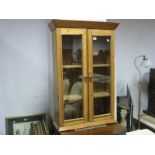 A XIX Century Pine Cabinet, with twin glazed doors, plinth base.