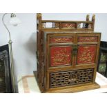 A Chinese Pine Cabinet, circa late XX Century, with twin doors, fretwork base and top, gilt and