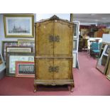 A XX Century Walnut Cocktail Cabinet, with a carved pediment cupboard doors, with brass lock plates,