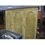 Maple & Co, Walnut Three Door Wardrobe, with a stepped pediment, interior with drawers etc, on small