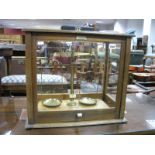 A Set of Chemists Scales in Glazed Mahogany Case, and a cased set of brass weights. (2)