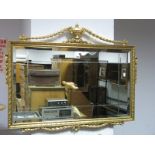 A Rectangular Bevelled Wall Mirror, with gilt frame having applied vase and ribbon decoration