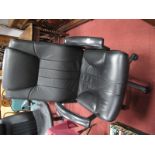 A Black Office Chair with adjustable action on back five star base. .
