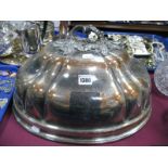 A Large Plated Copper Meat Dome, crested, with leaf scroll handle.