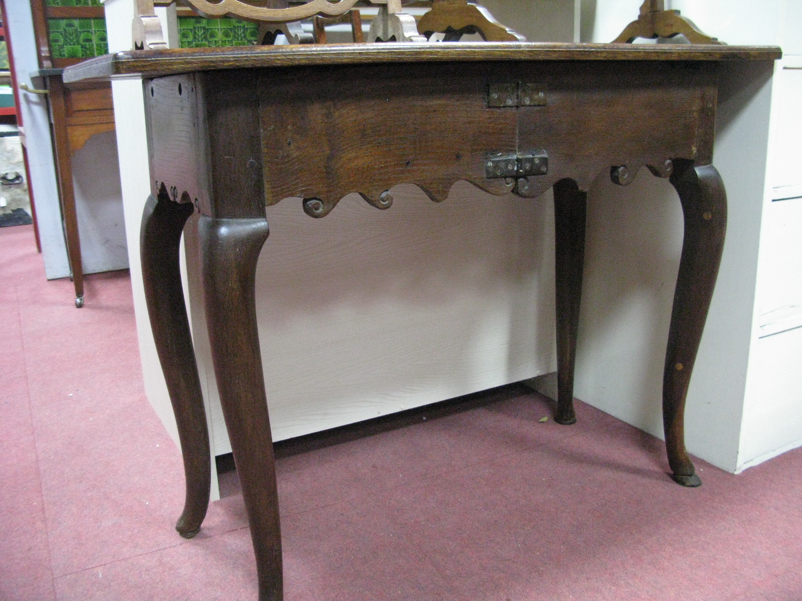 A Side Table, with a shaped apron, cabriole legs.