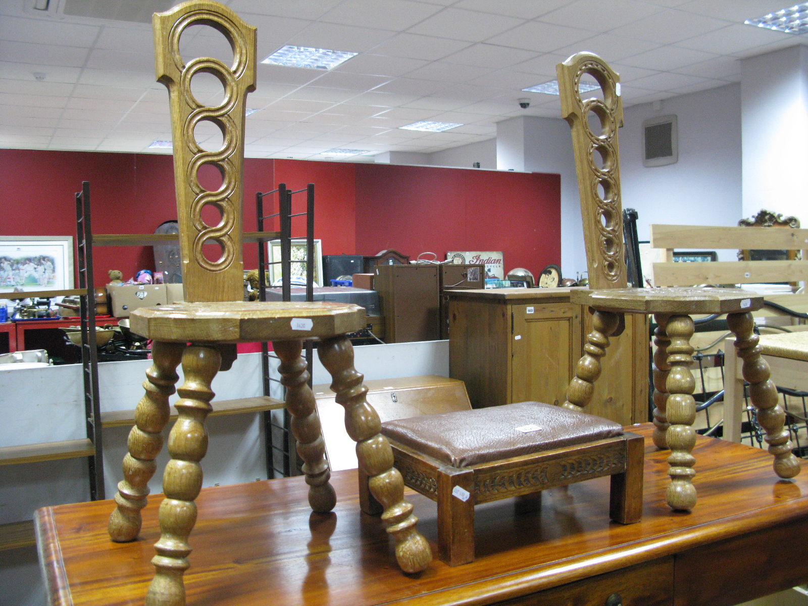 Two Oak Spinning Chairs, with pierced backs, curved seats, on bobbin legs, together with a foot