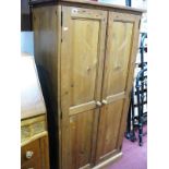A Pine Storage Cupboard with panelled doors and inner shelves, 76.5cm wide.