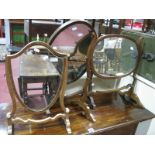 Two Mahogany Oval Dressing Table Mirrors, in 'S' scroll frames; another shield shape.