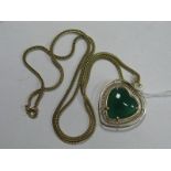 A Polished Green Hardstone Heart Shape Pendant, within openwork frame, on a chain indistinctly