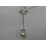 A Modern Pearl and Diamond Set Drop Pendant, of delicate elongated design, stamped "750" "NOAH", 5.