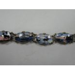 Ivar Holt: A Norwegian Enamel Bracelet, highlighted in pink, blue and black, detailed with reindeer,