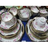 An Early XX Century Rose Floral Tea Service, of thirty nine pieces with blue and gilt borders.