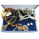 Modern Amber Bead Necklace, a dress ring and earrings, imitation pearl necklace, stud earrings.