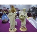 A Pair of Royal Worcester Figures of Cairo Water Carriers, each holding a large urn, their cream