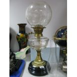 A Late XIX Century Oil Lamp, with glass funnel, engraved glass shade, well, brass pedestal,