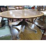 A Mahogany Oval Shaped Coffee Table, with a crossbanded top, turned pedestal, on swept legs.