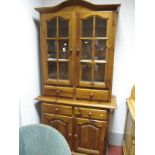 A Pine Kitchen Display Cabinet, with upper glazed doors over four drawers and cupboards.