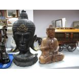 An Ebonized Wooden Oriental Head 54.5cm high, another seated. (2)