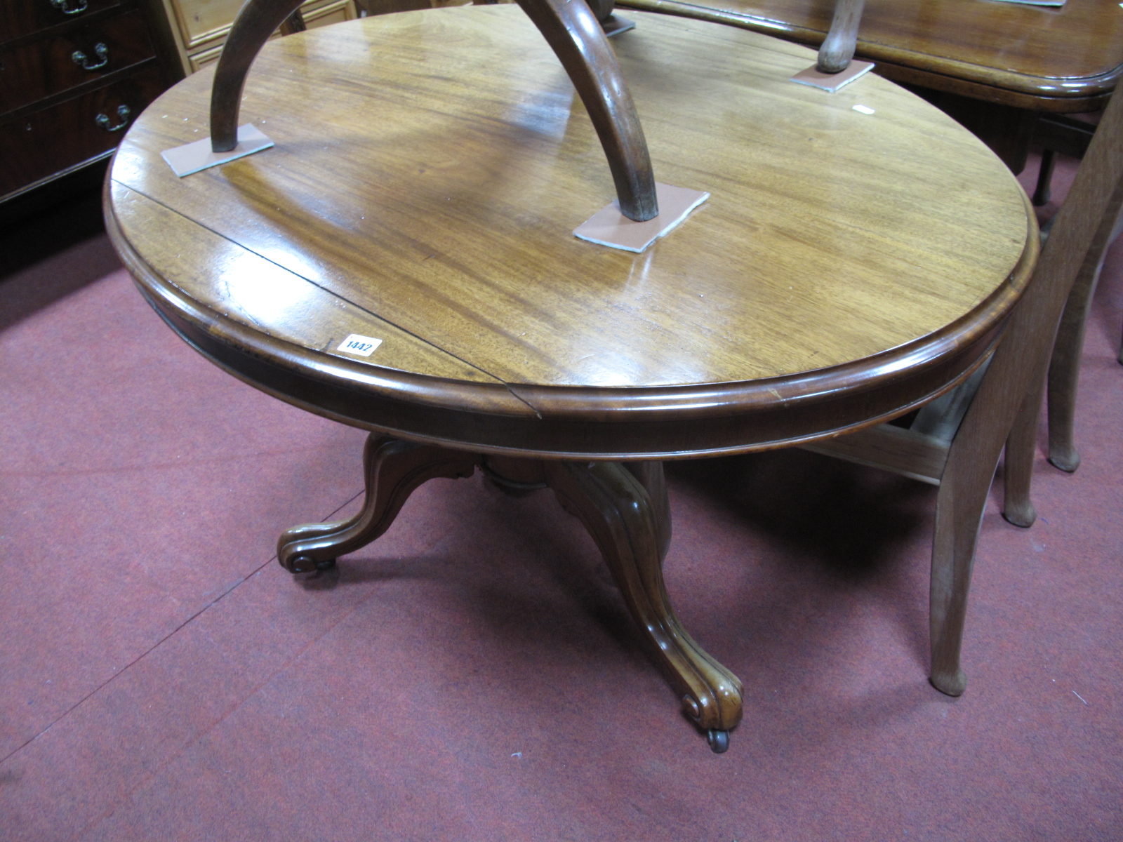 A XIX Century Mahogany Oval Shaped Loo Table, top with a moulded edge, turned pedestal table, on
