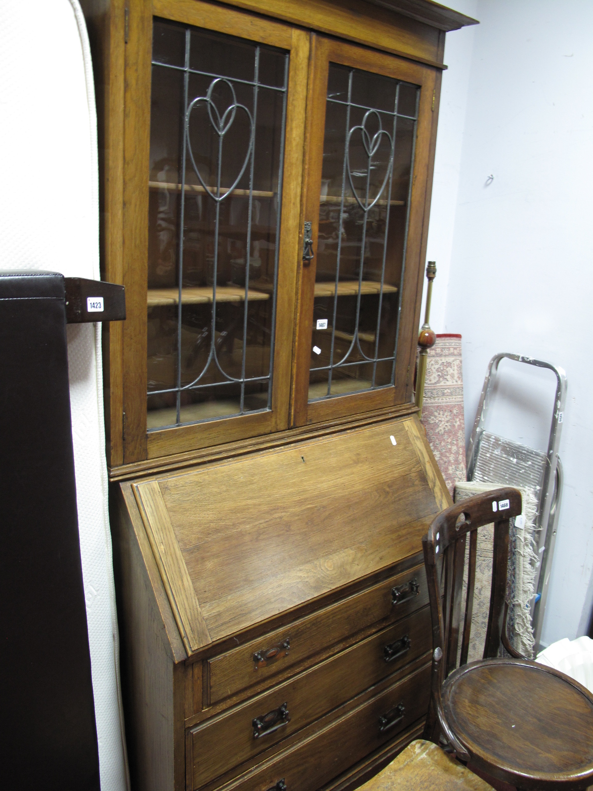 An Early XX Century Oak Bureau Bookcase, with leaded glazed doors, fall front, fitted interior,