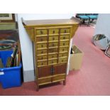 A Chinese Stained Pine Set of Eighteen Pigeon Hole Drawers, over cupboard doors 73.5cm wide.