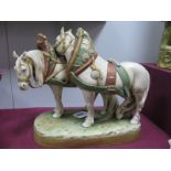 A Royal Dux Model of Two Horses, each with bridles and reins, upon a naturalistic rocky