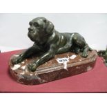 A Mid XX Century Bronze Model of an Old English Mastiff, in a recumbent pose, upon an oval red