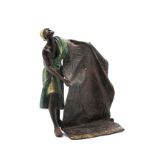 A Cold Painted Bronze Model in the Style of Bergman, of an Arab carpet seller, the reverse