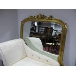 A XIX Century Style Gilt Overmantel Mirror, with scroll decoration, bevelled glass, in stepped