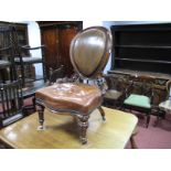 A XIX Century Walnut Spoon Back Nursing Chair, with brown leather back and seat, serpentine front