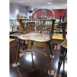 A XIX Century Yew Wood Windsor Chair, with hooped back, rail supports, crook arm supports, elm seat,