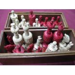 A Late XIX Century Bone Chess Set, with carved and turned pieces, half stained red, in an associated